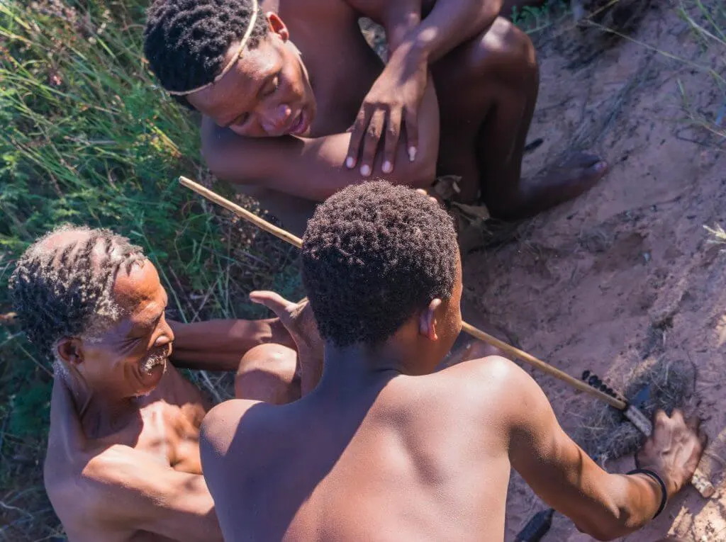 San Bushmen in Botswana walk and dance with the bushmen making fire