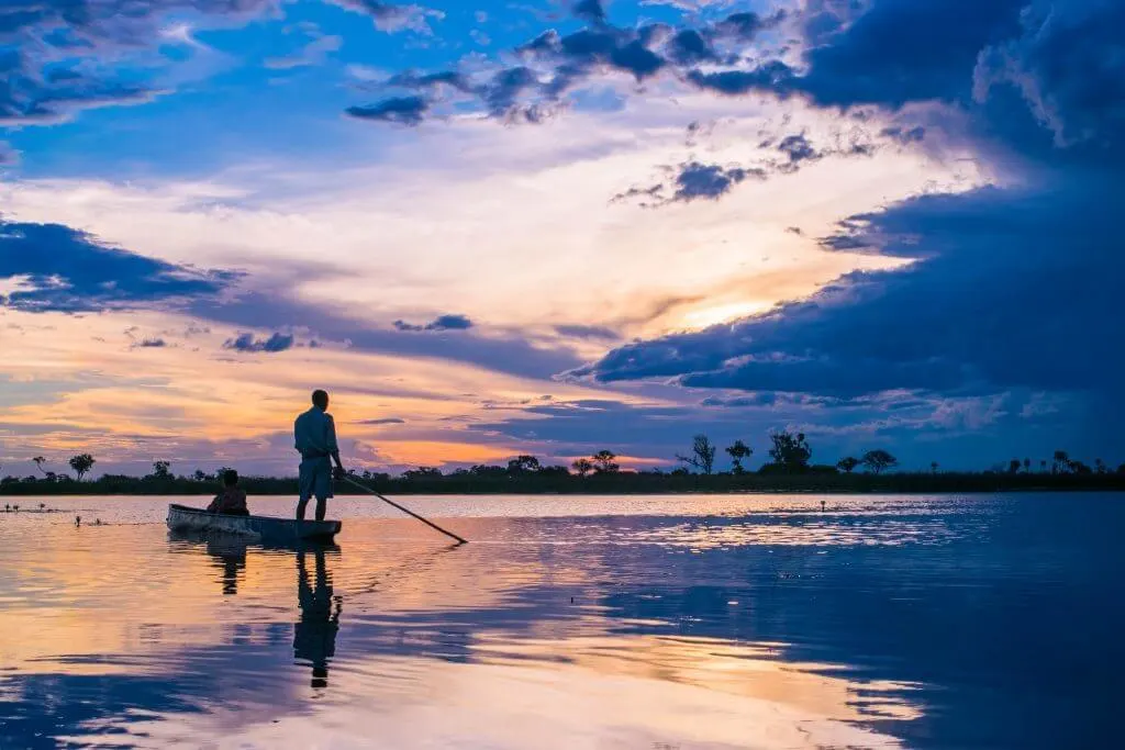 okavango delta safari sunset botswana mokoro boat