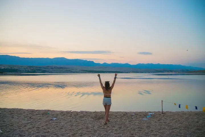 Hideout festival girl enjoying sunset on the beach