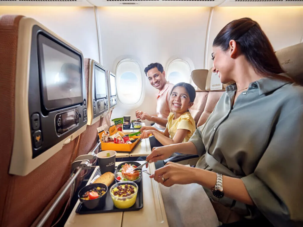 A family enjoying a mea during a flight