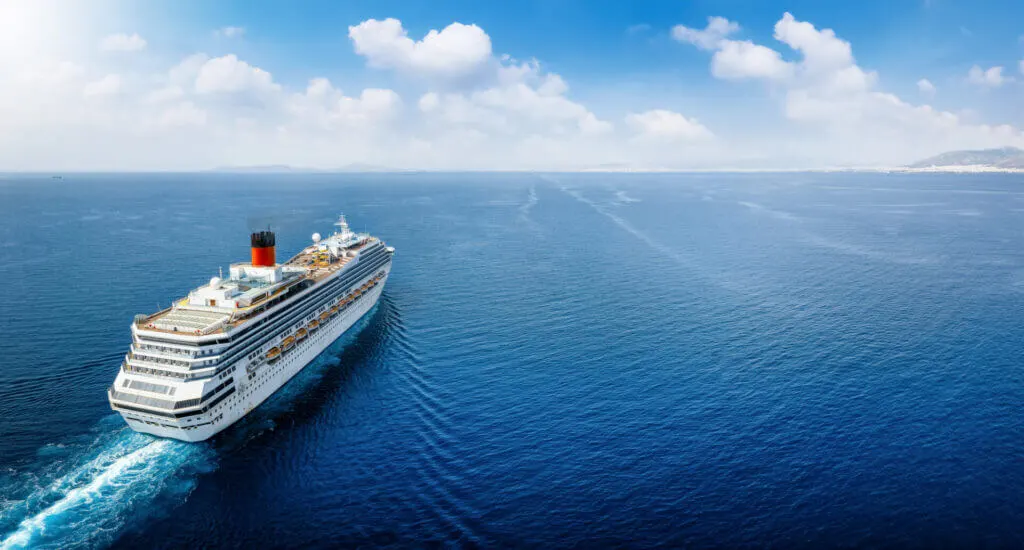 the pros and cons of travel on a yacht vs cruise ship, shot of cruise ship on the open ocean