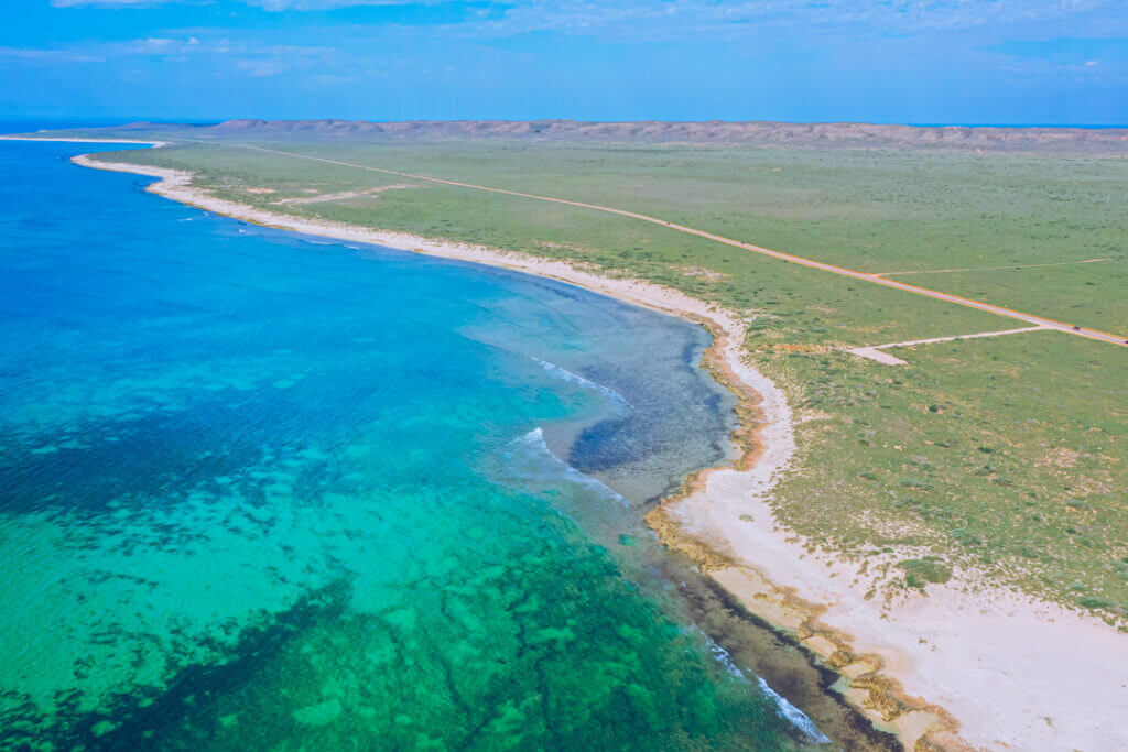 the peninsula near exmouth western australia from the sky with the classic WA red dirt - blue water!