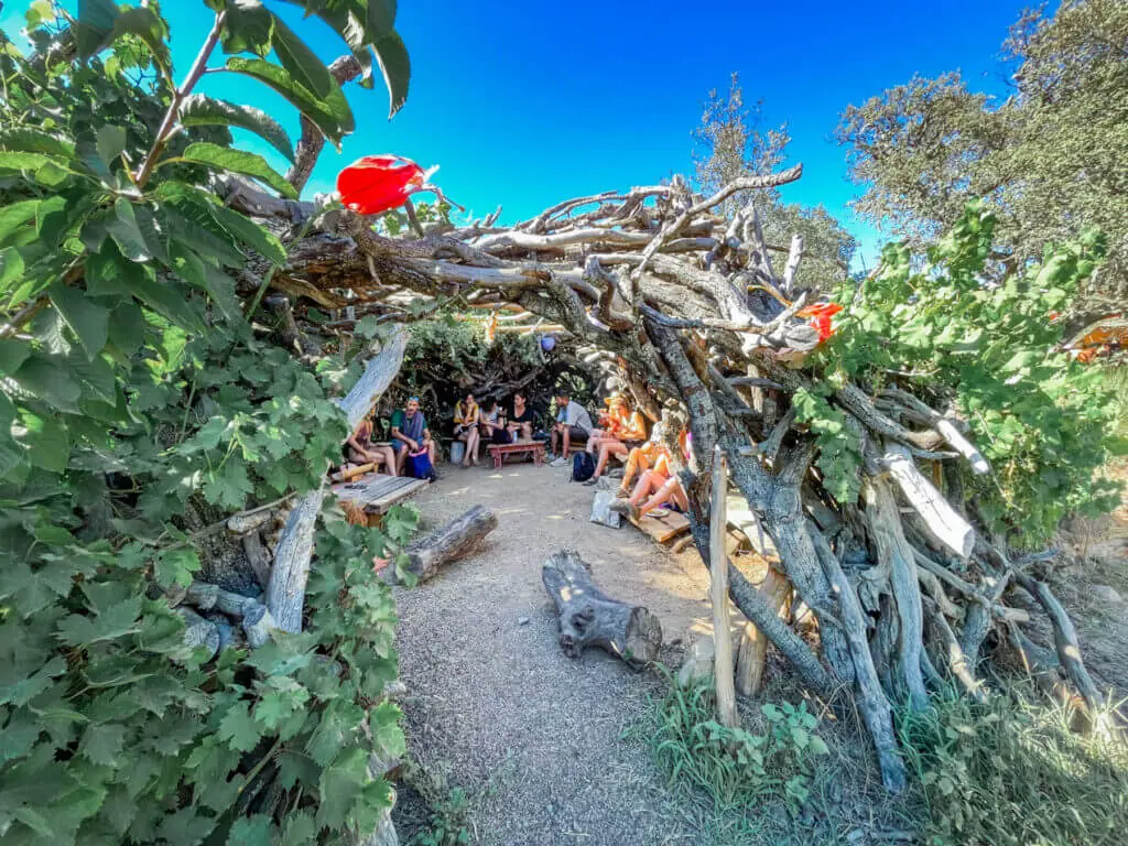 boom festival nook shade structure made from branches in sacred fire food area