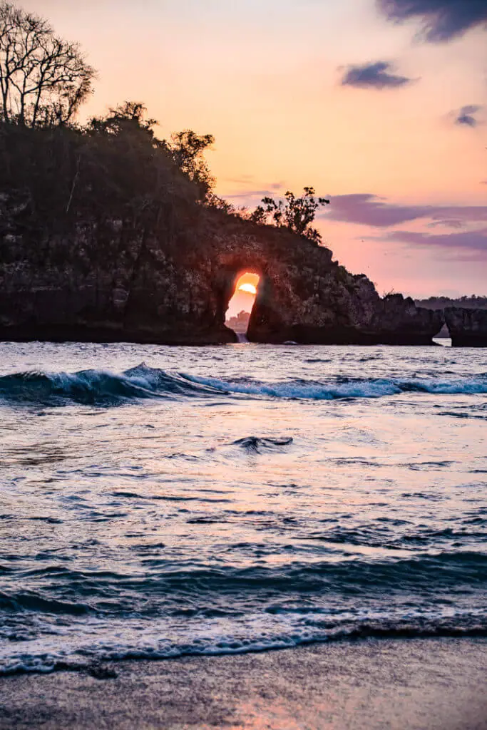 Nusa penida beach sunset through the rock arch bali 