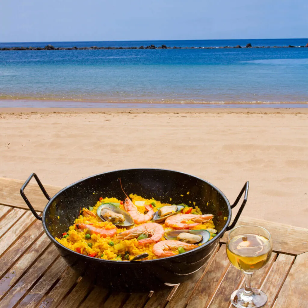 Paella is a must try food in spain things to know before you travel to Spain