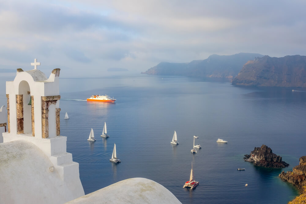 Yachts and a ferry off the coast of Santorini