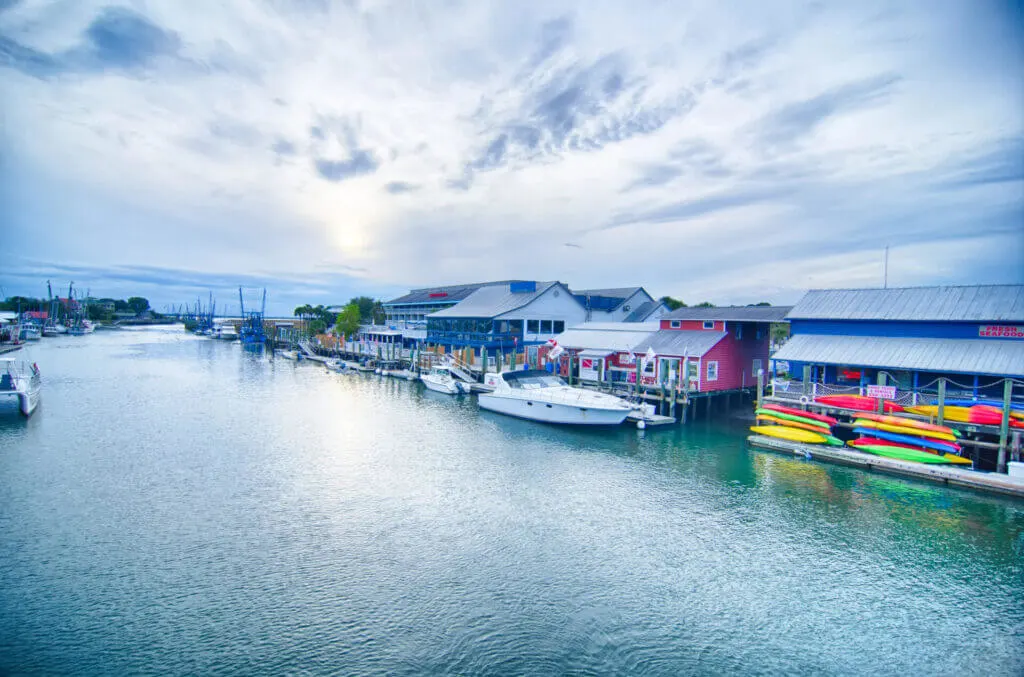 view of Shem Creek with kayaks and restaurants is a fun places with things to do in Charleston SC for couples with outdoors 