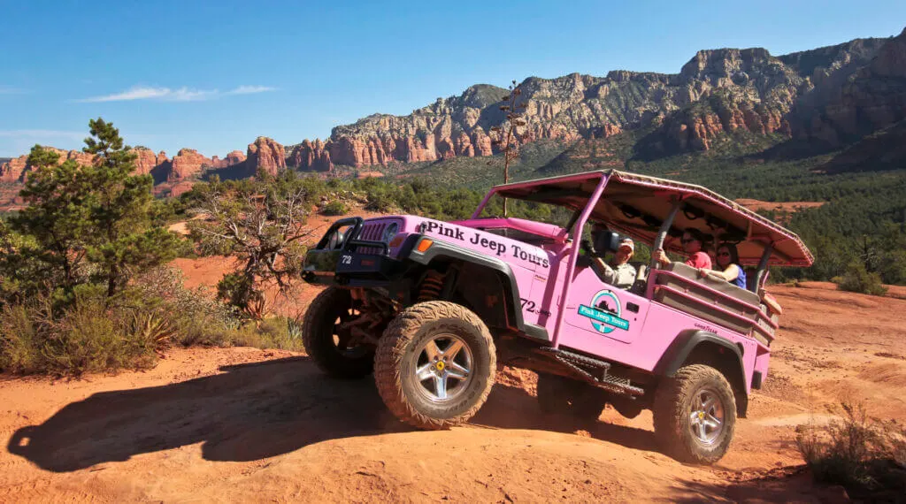 Pink jeep tour cruising through the Sedona Arizona desert
