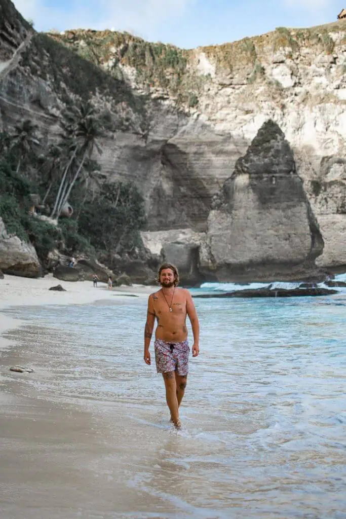 man walking at diamond beaches in nusa penida