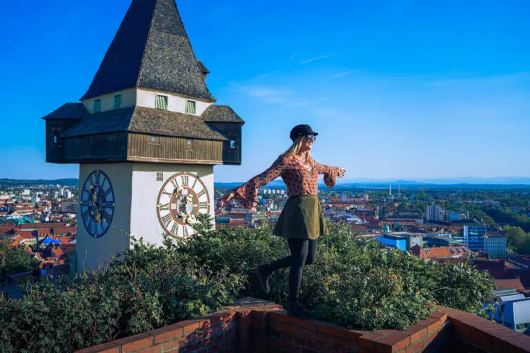 Is Graz Worth Visiting? Girl looks out over city in front of famous Graz clock tower