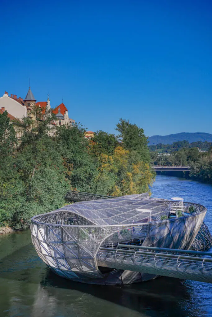 Graz Austria Scenery when driving Vienna to Graz - Graz Murinsel and mountains behind the Mur river