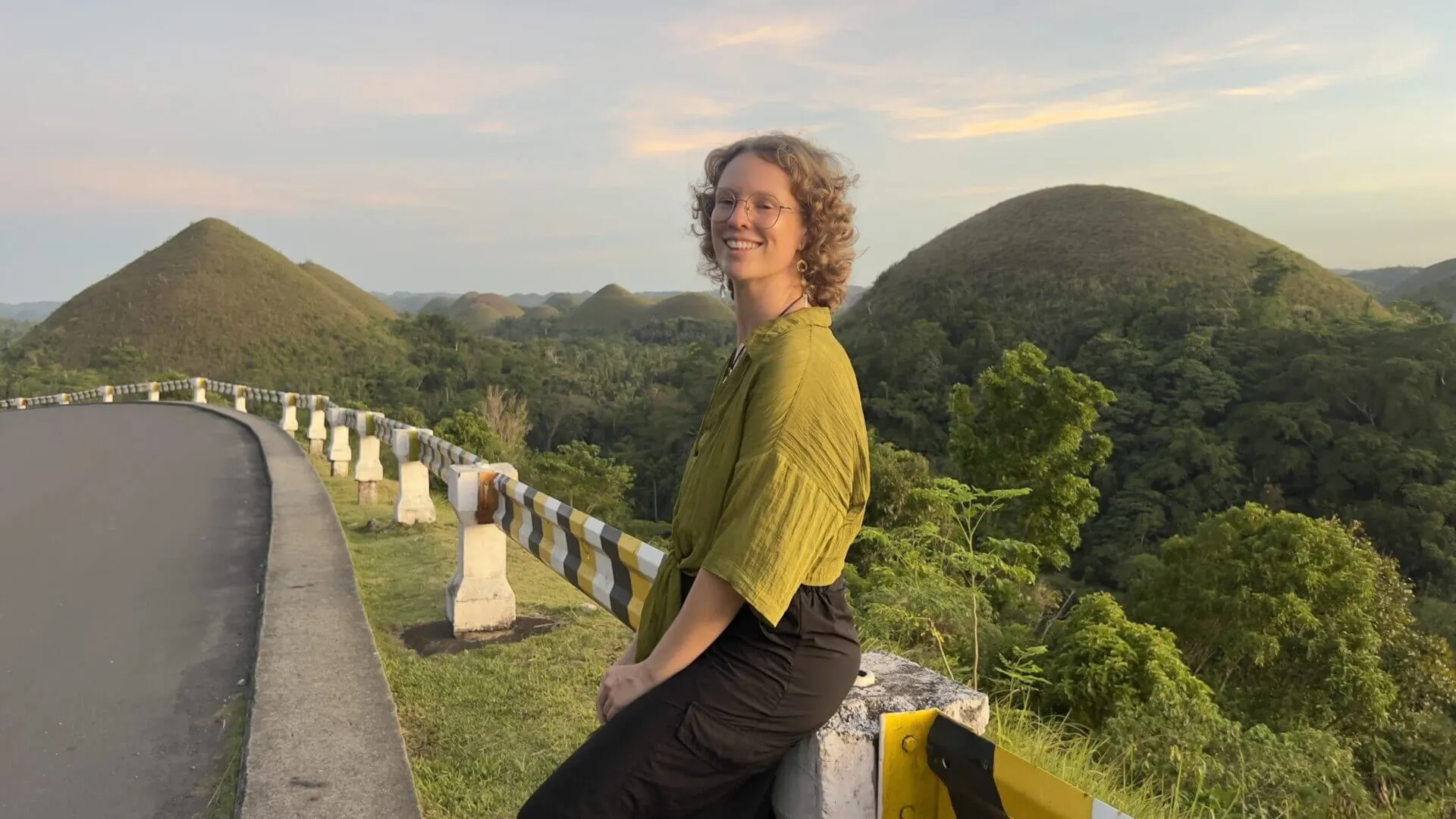 posing on the the road of one of the must do things in Bohol, visit the Chocolate Hills