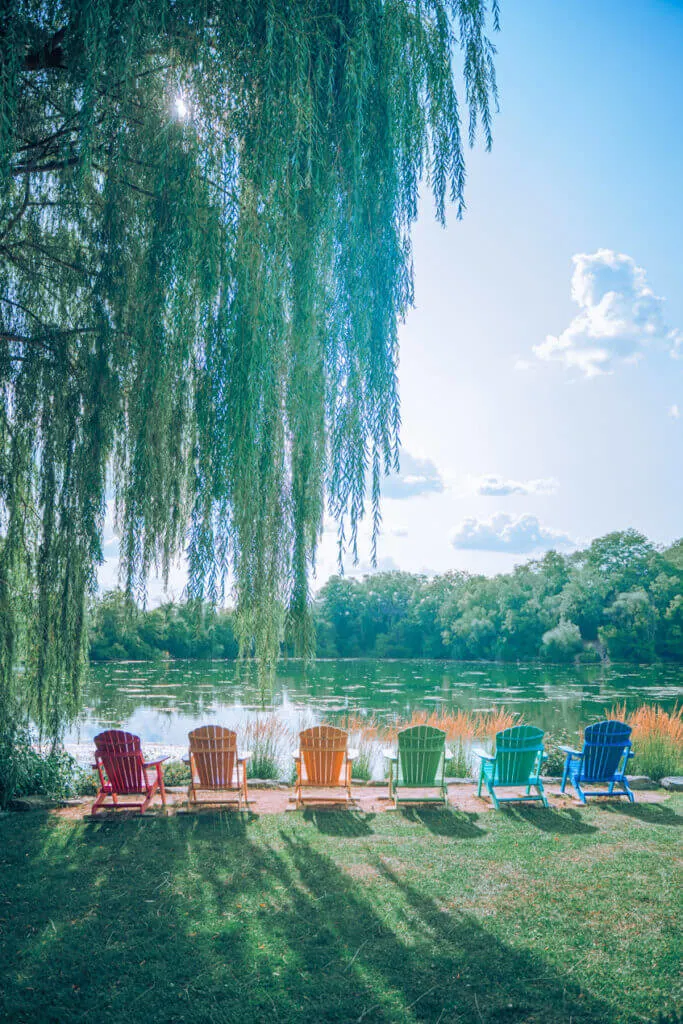 Rotary Botanical Gardens Janesville rainbow adirondack chairs overlooking a lake