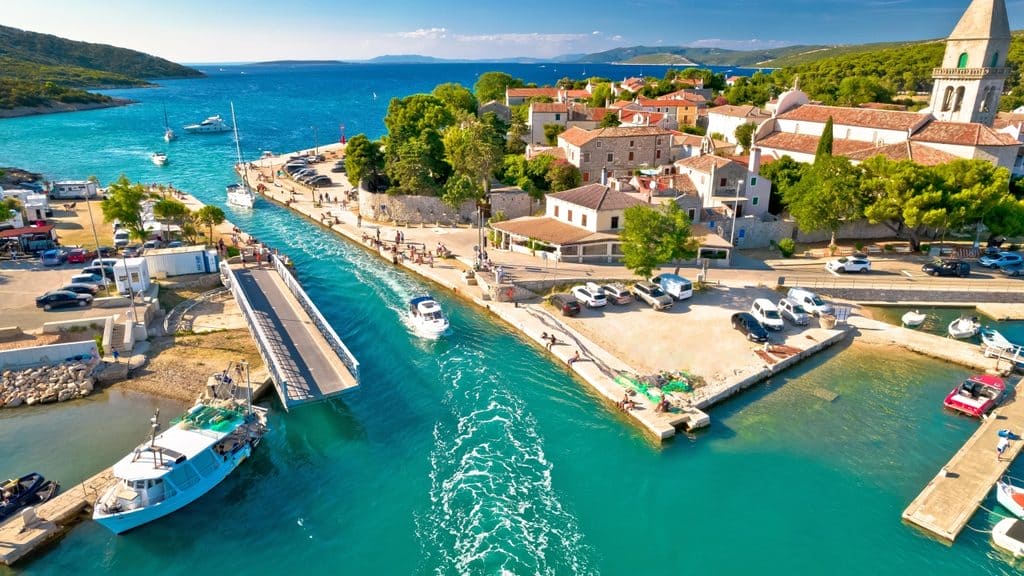 A beautiful view of Mali Lošinj harbor and the surrounding pine forests