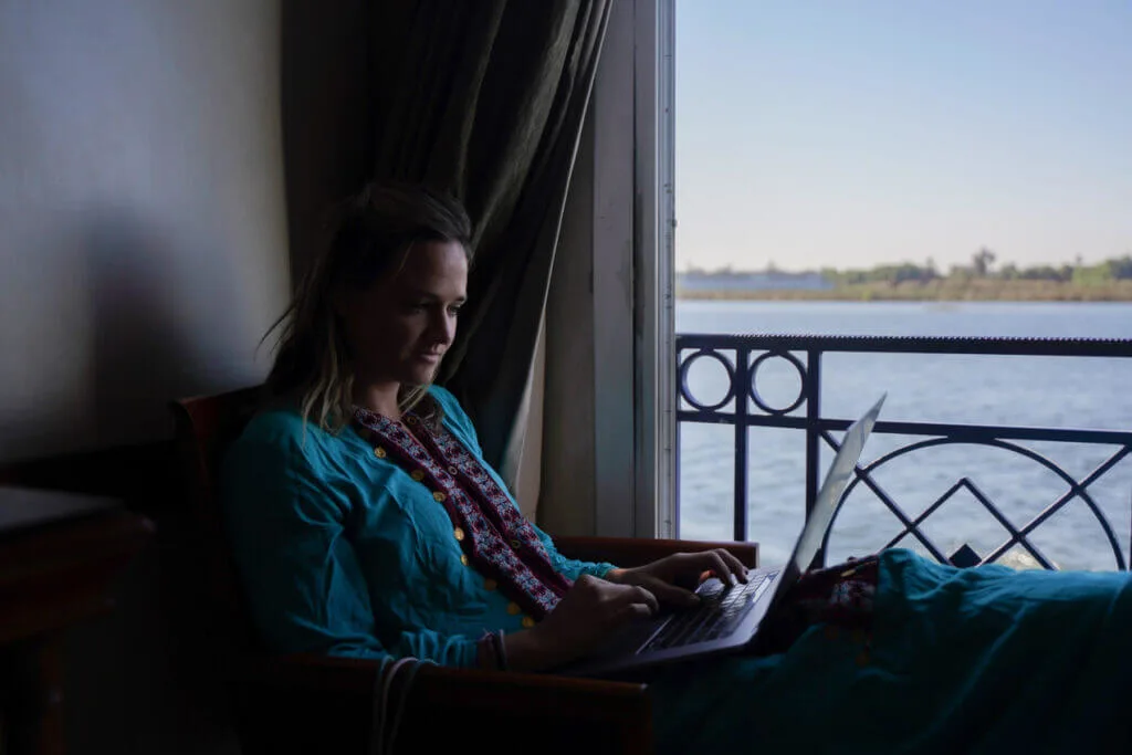 girl on laptop while traveling wanderlust cure