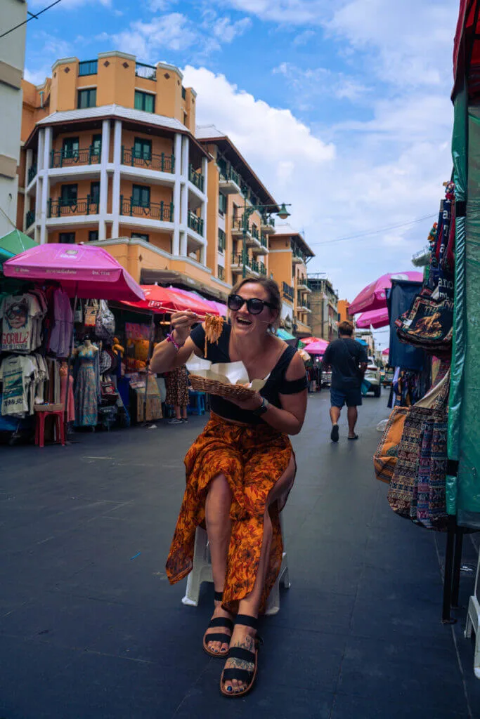 travel blogger kimmei conner Enjoying a street pad thai on Khao San road bangkok