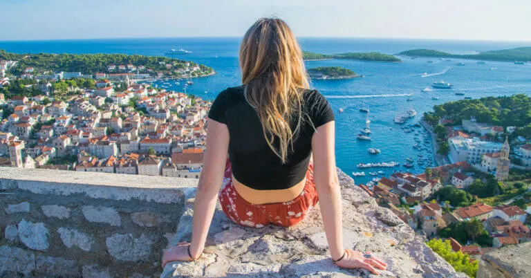 planning a trip to croatia? start here - girl on castle on hvar island