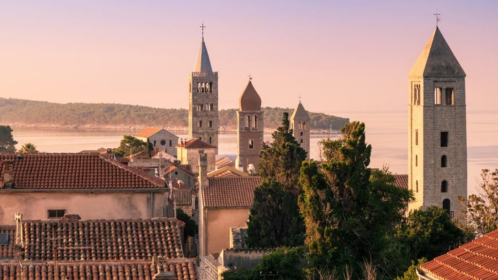 The medieval skyline of Rab Town with four stone bell towers by the Adriatic sea