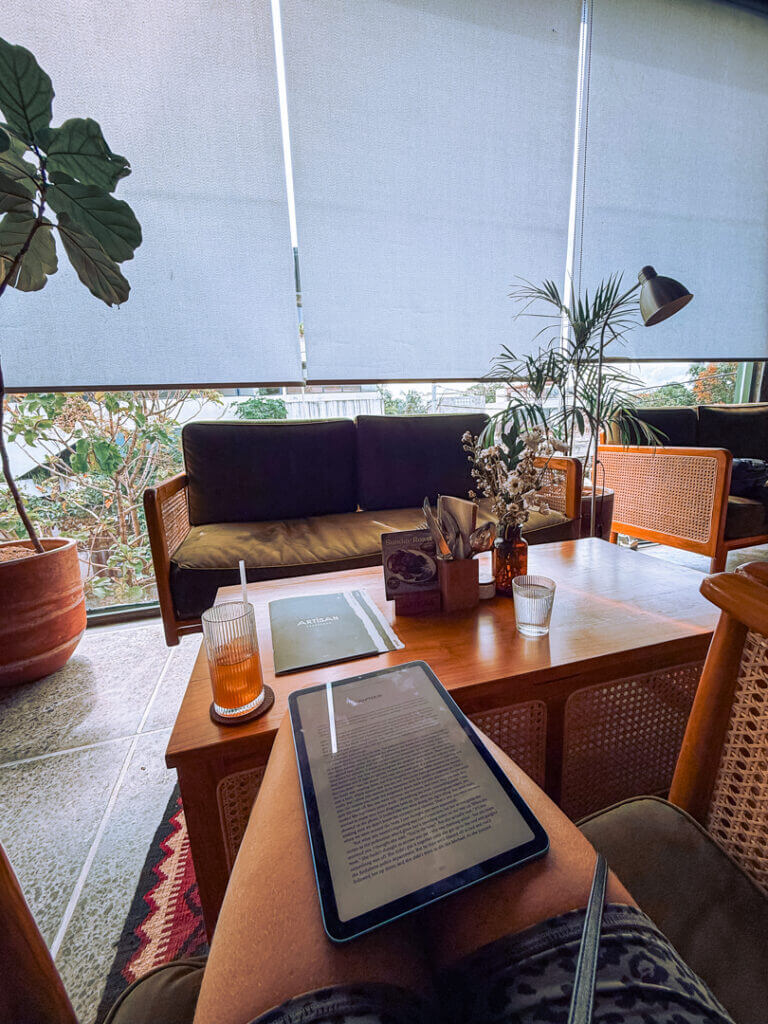 reading on the kindle at a cafe during rain