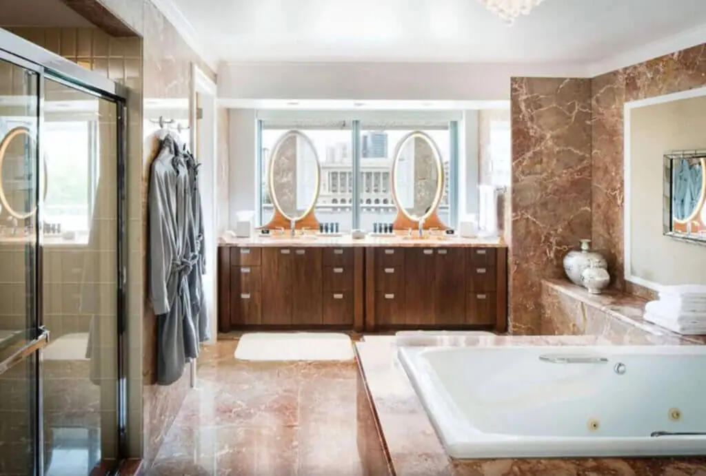 The Logan Philadelphia hotel bathroom with hot tub, robes, and his and hers mirrors