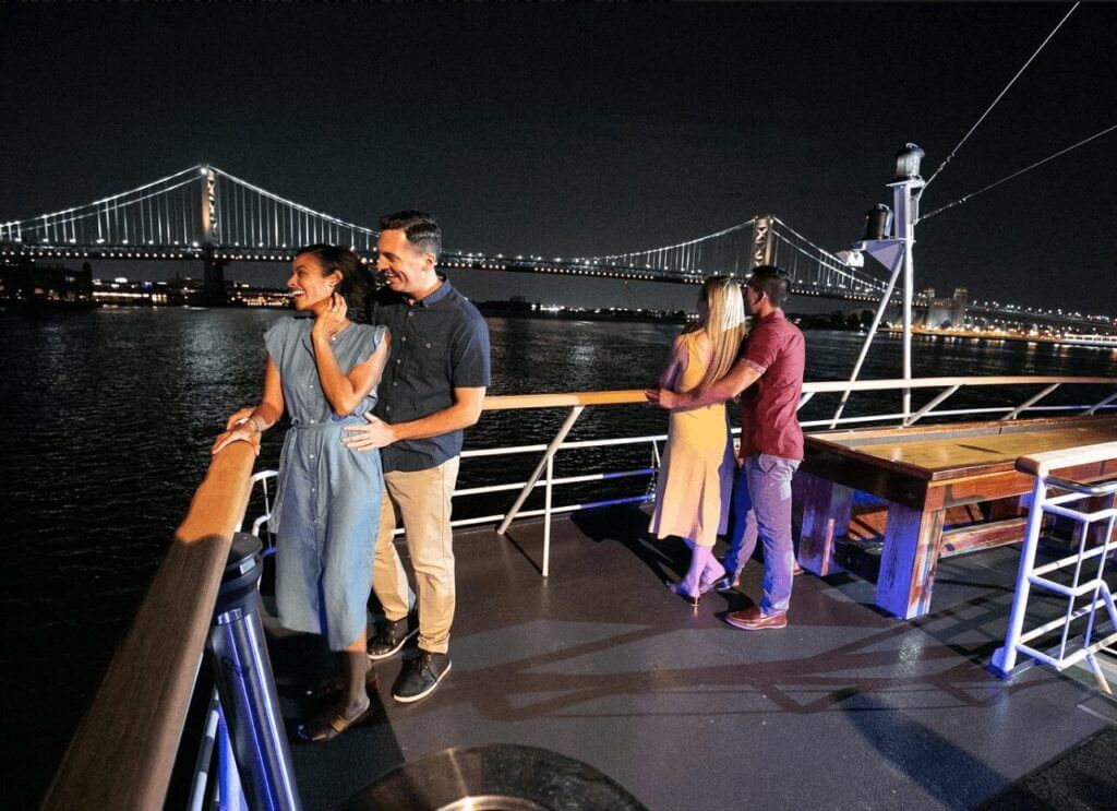 couples on a romantic dinner cruise in Philadelphia with the Ben Franklin Bridge in the distance