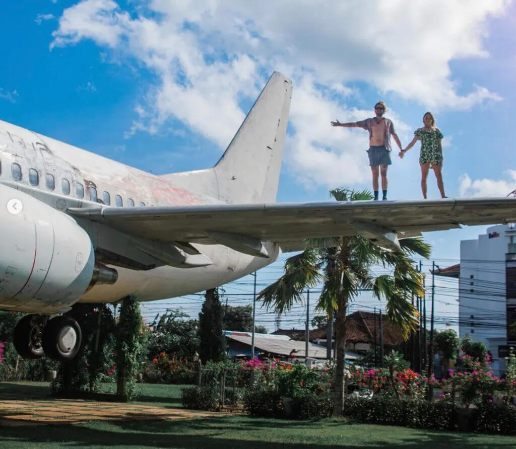 abandoned airplanes in Bali - Kuta abandoned airplane with travel couple on the wing