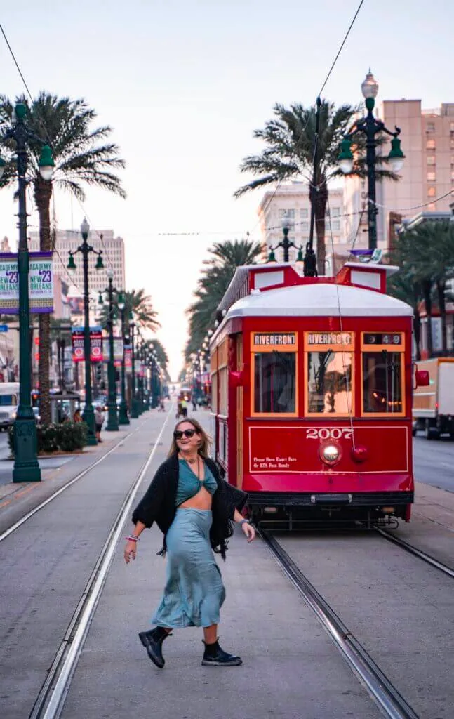 girl walking by tram on canal street new orleans