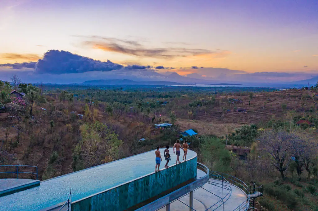 sumberkima hill elevated pool sunset drone shot