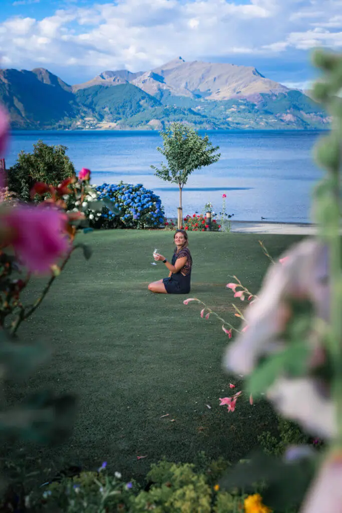 Walter Peak high country farm gardens TSS Earnslaw cruise girl in field drinking wine