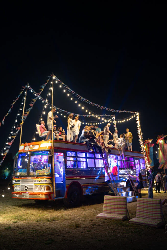 wonderfruit crowd and vibe climbing bus at molam