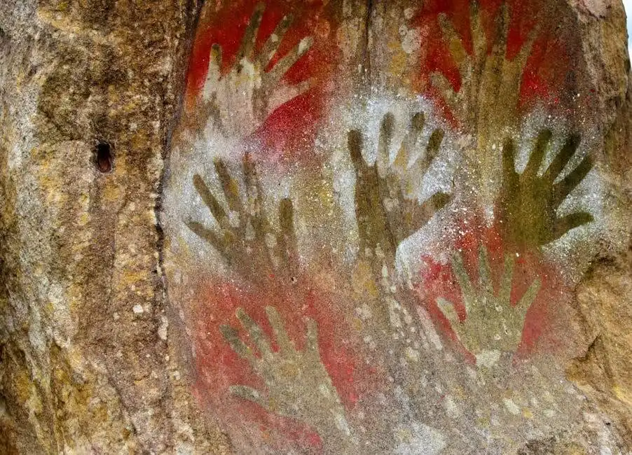 Neolithic hand print art painted on cave wall illustrates ancient history.