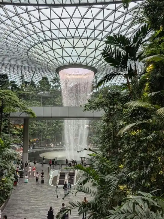 Explore the indoor waterfall and lush greenery of Jewel Changi Airport in Singapore.